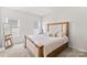 Serene main bedroom featuring a large bed with a decorative headboard and ample natural light at 13920 Winmau Ln, Huntersville, NC 28078