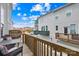 Outdoor patio featuring a wooden railing, furniture, and a view of the neighborhood at 13920 Winmau Ln, Huntersville, NC 28078