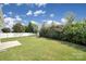 Manicured backyard with lush lawn and a partial patio at 15120 Cavanshire Trl, Charlotte, NC 28278