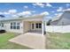 Backyard featuring a covered patio and brick-paved area at 15120 Cavanshire Trl, Charlotte, NC 28278