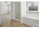 Bathroom featuring a soaking tub, shower, and large window at 15120 Cavanshire Trl, Charlotte, NC 28278