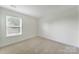 Bedroom with neutral carpet and a large window at 15120 Cavanshire Trl, Charlotte, NC 28278