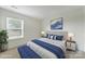 This staged bedroom has blue accents and a large window at 15120 Cavanshire Trl, Charlotte, NC 28278