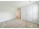 Bright bedroom features neutral carpet and large closet for storage at 15120 Cavanshire Trl, Charlotte, NC 28278