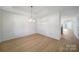 Bright dining area with tray ceiling, hardwood floors, wainscoting and lots of natural light at 15120 Cavanshire Trl, Charlotte, NC 28278