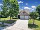 Exterior of home with well-manicured lawn and a two-car garage at 15120 Cavanshire Trl, Charlotte, NC 28278