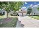 Home exterior showcasing a well-kept lawn and two-car garage at 15120 Cavanshire Trl, Charlotte, NC 28278