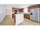 Well-lit kitchen featuring stainless steel appliances, wood cabinets, breakfast bar and hardwood floors at 15120 Cavanshire Trl, Charlotte, NC 28278