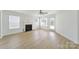 Bright living room with hardwood floors, a fireplace, and a back door to access the yard at 15120 Cavanshire Trl, Charlotte, NC 28278