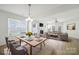 Bright living room features modern furnishings, a fireplace, and large windows for ample natural light at 15120 Cavanshire Trl, Charlotte, NC 28278