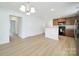 Living room with hardwood floors next to the kitchen, featuring granite counters and stainless appliances at 15120 Cavanshire Trl, Charlotte, NC 28278