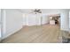 Spacious living room with hardwood floors and access to the kitchen and other rooms at 15120 Cavanshire Trl, Charlotte, NC 28278