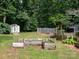 Backyard featuring a garden, wooded area, and tool shed at 170 Eagle Dr, Salisbury, NC 28144