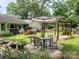 Backyard with patio furniture, swing, lush garden, and a glimpse of the home's exterior at 170 Eagle Dr, Salisbury, NC 28144