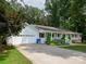 Home with attached garage, long driveway, front porch, and manicured landscaping at 170 Eagle Dr, Salisbury, NC 28144