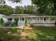 Charming home featuring a full-length front porch, lovely landscaping, and classic American style at 170 Eagle Dr, Salisbury, NC 28144