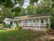 Traditional home featuring a full-length front porch and manicured landscaping at 170 Eagle Dr, Salisbury, NC 28144