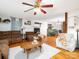 Living room featuring hardwood floors, ceiling fan, fireplace and neutral colored furniture at 170 Eagle Dr, Salisbury, NC 28144