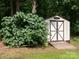 Exterior view of a storage shed near mature landscaping and level lot at 170 Eagle Dr, Salisbury, NC 28144