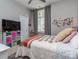 A bright bedroom with a window, stylish decor, and organized storage solutions at 17709 Sedona Way, Cornelius, NC 28031