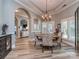 Elegant dining room featuring hardwood floors, a stylish chandelier, and arched doorways to other areas at 17709 Sedona Way, Cornelius, NC 28031