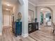 Bright hallway with hardwood floors, showcasing decorative cabinets and an arched doorway to the living area at 17709 Sedona Way, Cornelius, NC 28031