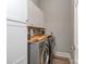 Efficient laundry room with modern washer and dryer, ample counter space, and storage cabinets at 17709 Sedona Way, Cornelius, NC 28031
