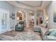 Open-concept living room with hardwood floors, comfortable seating, and arched doorways to other spaces at 17709 Sedona Way, Cornelius, NC 28031