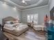 Tranquil primary bedroom featuring tray ceilings, a ceiling fan, and plenty of natural light at 17709 Sedona Way, Cornelius, NC 28031