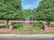 Scenic pond with fountain, surrounded by trees, flowers and brick landscaping at 17709 Sedona Way, Cornelius, NC 28031