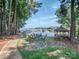 Scenic waterfront view with a gazebo and seating area overlooking the lake and boat docks at 17709 Sedona Way, Cornelius, NC 28031