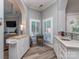 Stylish wet bar with white cabinetry, a wine cooler, and modern fixtures, perfect for entertaining at 17709 Sedona Way, Cornelius, NC 28031