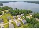 Aerial view of homes with lake access featuring manicured lawns and mature trees at 18568 Mainsail Ct, Lancaster, SC 29720