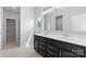 Bathroom with a dual sink vanity, large mirrors, and a doorway to the shower at 18568 Mainsail Ct, Lancaster, SC 29720