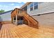 Spacious wooden deck with an outdoor spa, surrounded by a lush backyard at 18568 Mainsail Ct, Lancaster, SC 29720