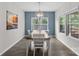 Bright dining room featuring a modern chandelier, large windows, and a dark wood table at 18568 Mainsail Ct, Lancaster, SC 29720