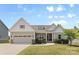 Charming single-Gathering home with a two-car garage, a manicured lawn, and stone and siding accents at 18568 Mainsail Ct, Lancaster, SC 29720