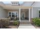 Inviting front porch with stone accents, decorative columns, and a cozy seating area, perfect for relaxing at 18568 Mainsail Ct, Lancaster, SC 29720