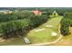 An expansive green golf course surrounded by tall trees, featuring sand traps and manicured greens at 18568 Mainsail Ct, Lancaster, SC 29720