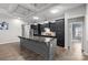 Stylish kitchen with black cabinets, a large island with a marble countertop, and stainless steel appliances at 18568 Mainsail Ct, Lancaster, SC 29720