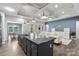 Bright kitchen and living room space with a large island, pendant lighting, and an open-concept design at 18568 Mainsail Ct, Lancaster, SC 29720