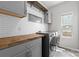 A laundry room featuring gray cabinets, wood countertops, and appliances at 18568 Mainsail Ct, Lancaster, SC 29720