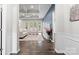 Elegant living room with tray ceilings, hardwood floors, an accent wall, and plenty of natural light at 18568 Mainsail Ct, Lancaster, SC 29720