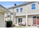 A spacious backyard featuring a patio seating area, lawn space, and rear building facade at 2726 Tranquil Oak Pl, Charlotte, NC 28206