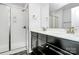 Modern bathroom with glass shower and double vanity with dark cabinetry at 2726 Tranquil Oak Pl, Charlotte, NC 28206
