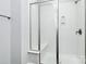 Bright bathroom featuring a glass-enclosed shower with built-in bench and modern fixtures at 2726 Tranquil Oak Pl, Charlotte, NC 28206