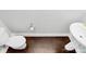 Compact bathroom with modern toilet and sink set on dark wood floor at 2726 Tranquil Oak Pl, Charlotte, NC 28206