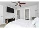 Stylish bedroom with a ceiling fan and TV, offering ample space and contemporary décor at 2726 Tranquil Oak Pl, Charlotte, NC 28206