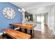 Dining area with a large wooden table and seating, adjacent to an open kitchen at 2726 Tranquil Oak Pl, Charlotte, NC 28206