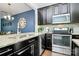 Stylish kitchen with stainless steel appliances, granite counters, and dark cabinetry at 2726 Tranquil Oak Pl, Charlotte, NC 28206